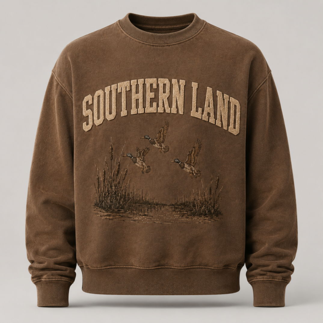 Flight Crew crewneck in tobacco with raised Southern Land lettering above a marsh flight line